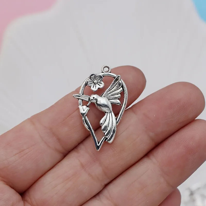 Gold-tone alloy magpie pendant charm for DIY jewellery making on a white background.