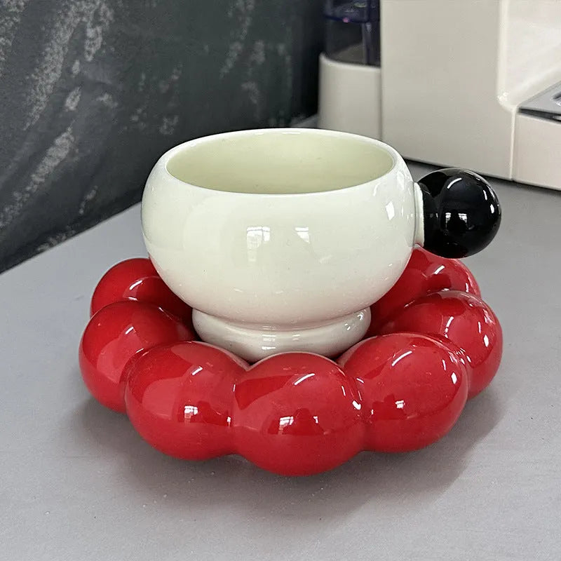Ceramic coffee cup and saucer set in a simple Nordic design, shown in a choice of colours.