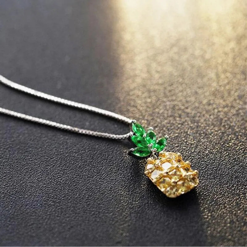 Silver geometric women's necklace with a pineapple and diamond motif pendant.