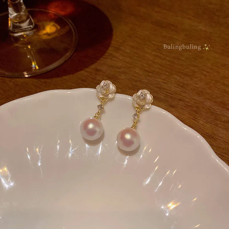 Camellia flower stud earrings with alloy construction and floral detailing