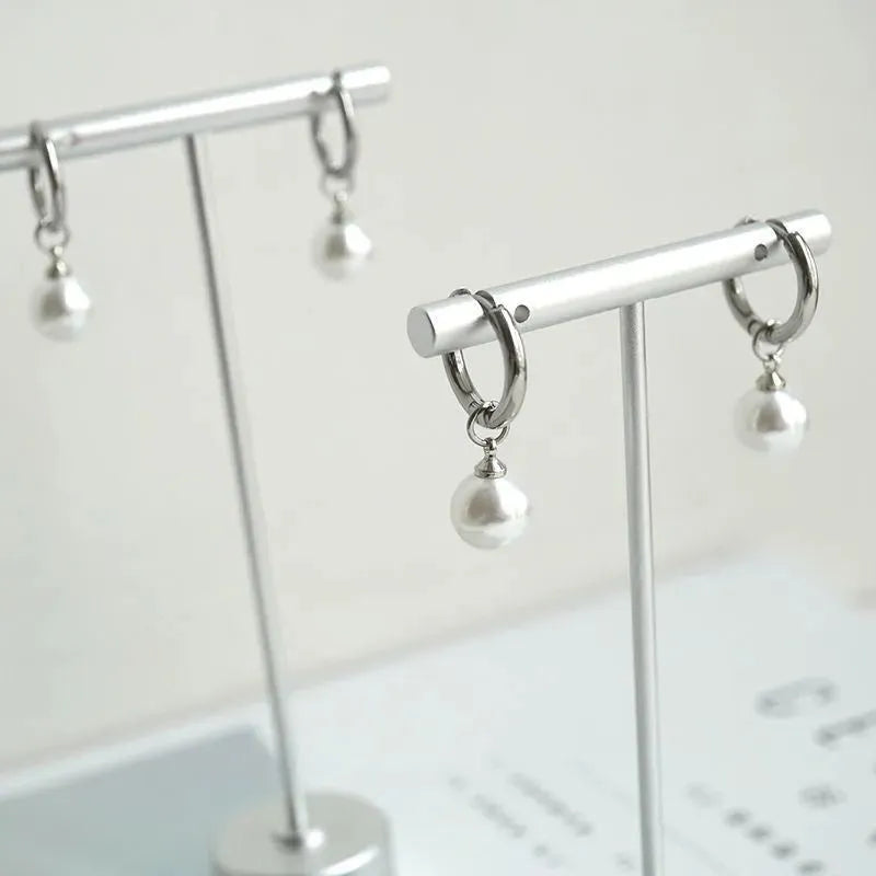 Geometric pearl hoop earrings with circular design and titanium steel alloy construction