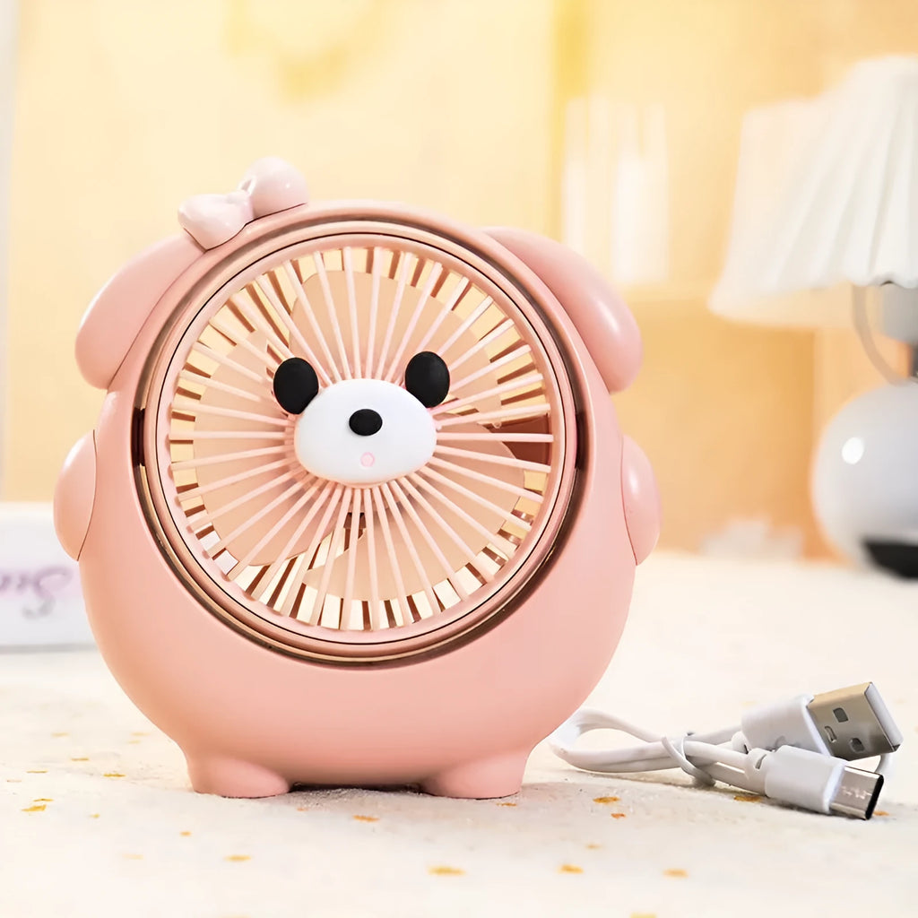 Small plastic desktop fan with a cute dog design, showing USB port and control buttons.