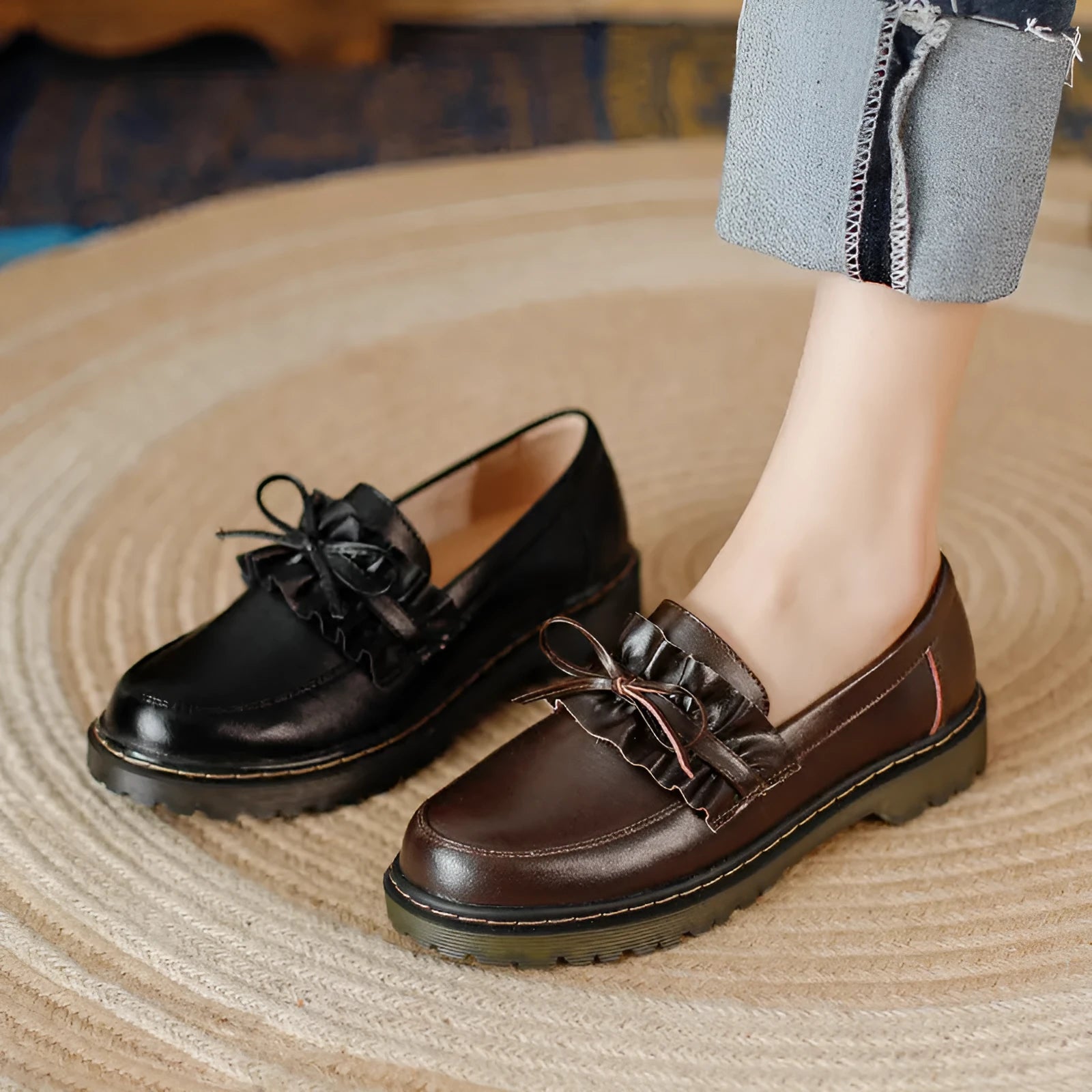 Black round-toe women's leather shoes with a chunky flat heel on a white background
