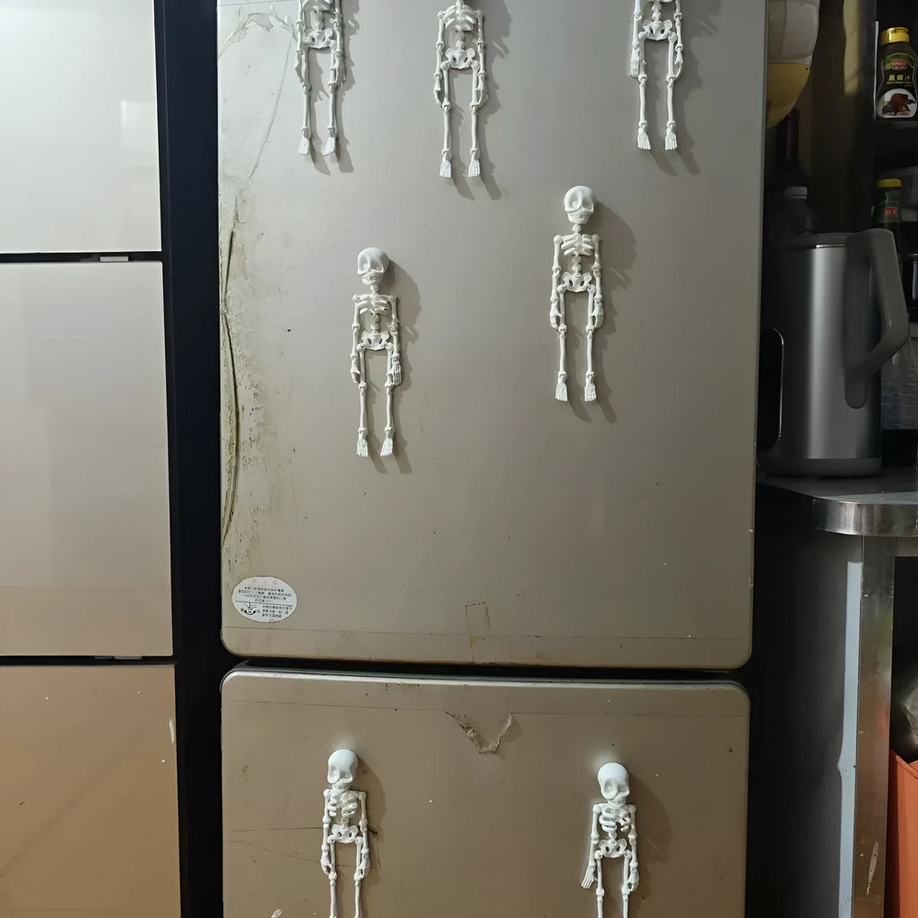 3D printed white skull refrigerator magnet with intricate details on a metallic surface.