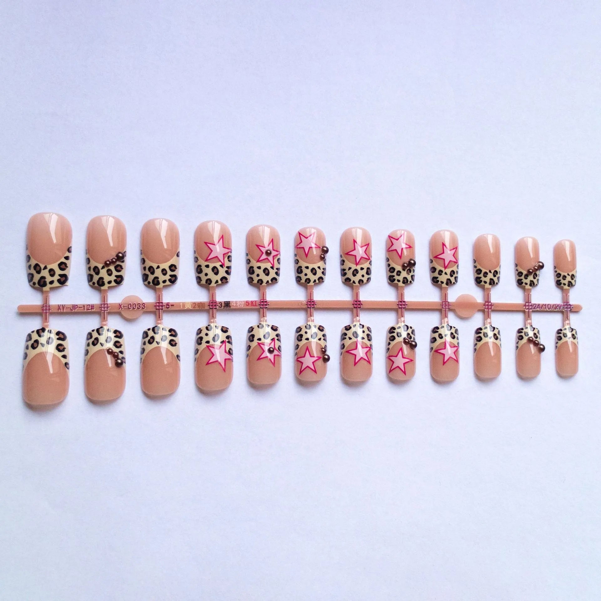 French style leopard print nail art strips with pearl and five-pointed star decorations for manicures.