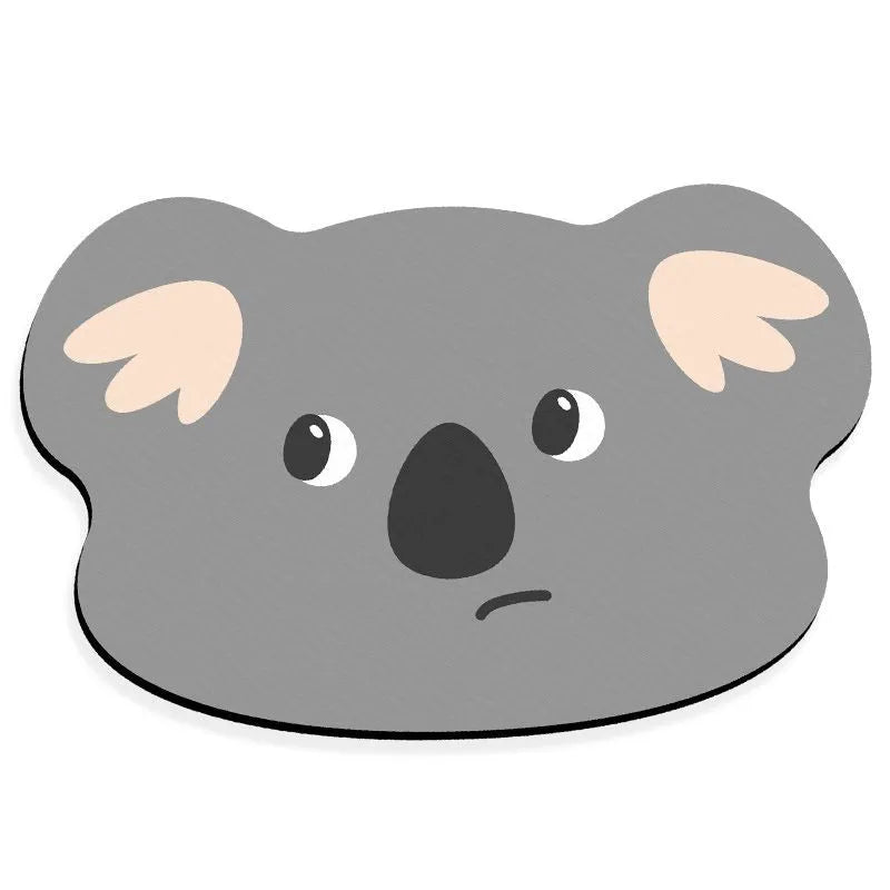 Cartoon animal diatomite absorbent bathroom mat in alien shape on bathroom floor.