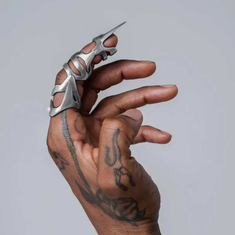 Silver-coloured punk armour finger stall ring made of alloy.