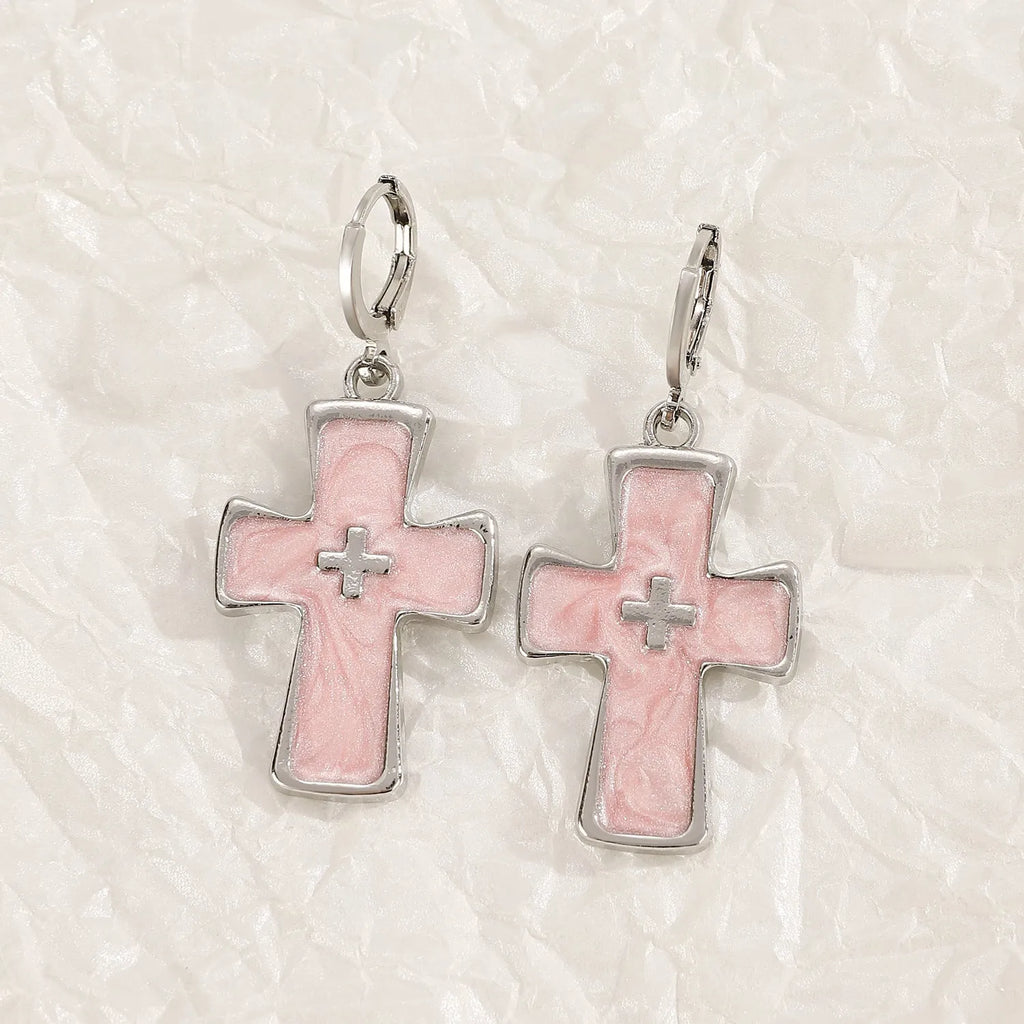 Women's classic alloy earrings with cross crystal design in five colour options on display