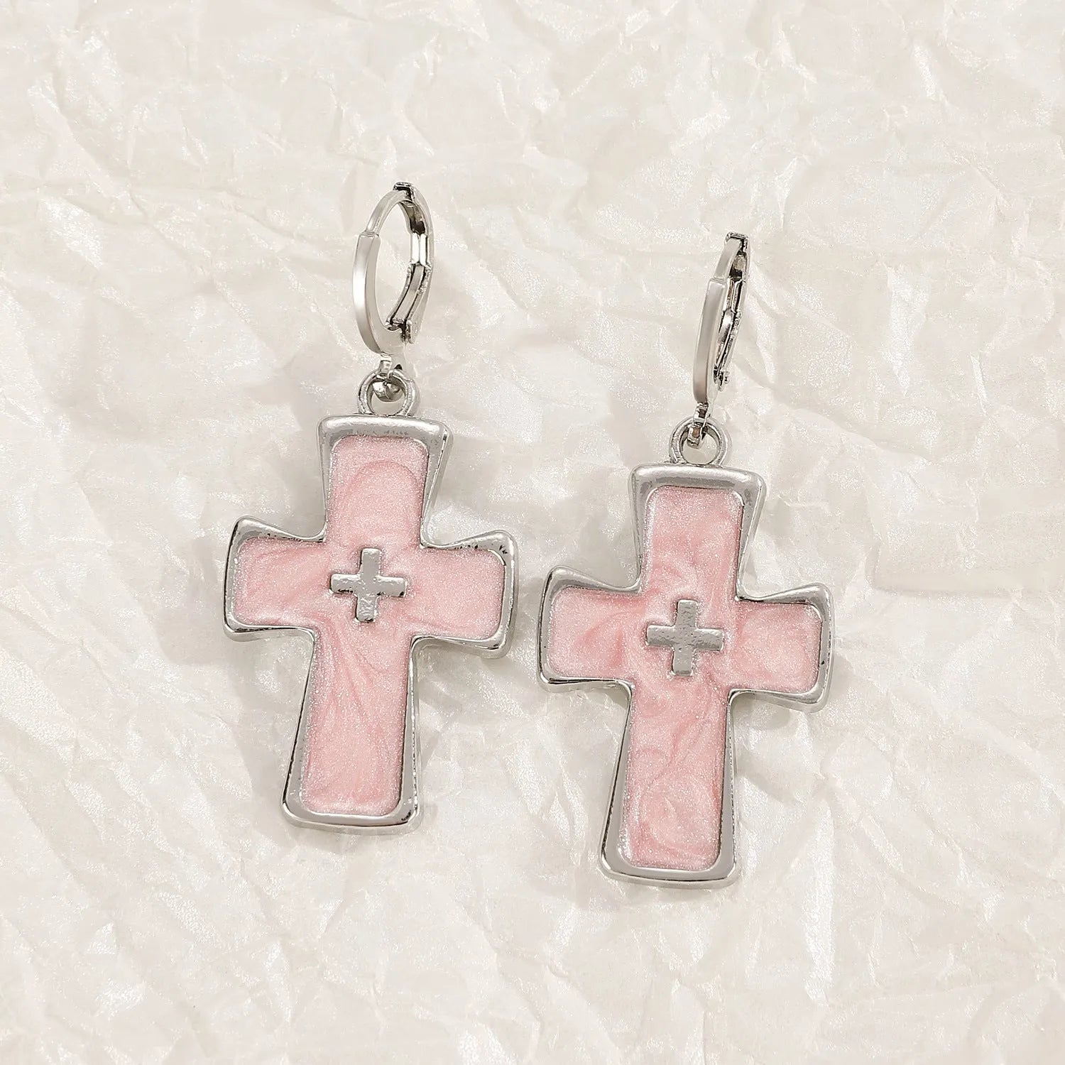 Women's classic alloy earrings with cross crystal design in five colour options on display