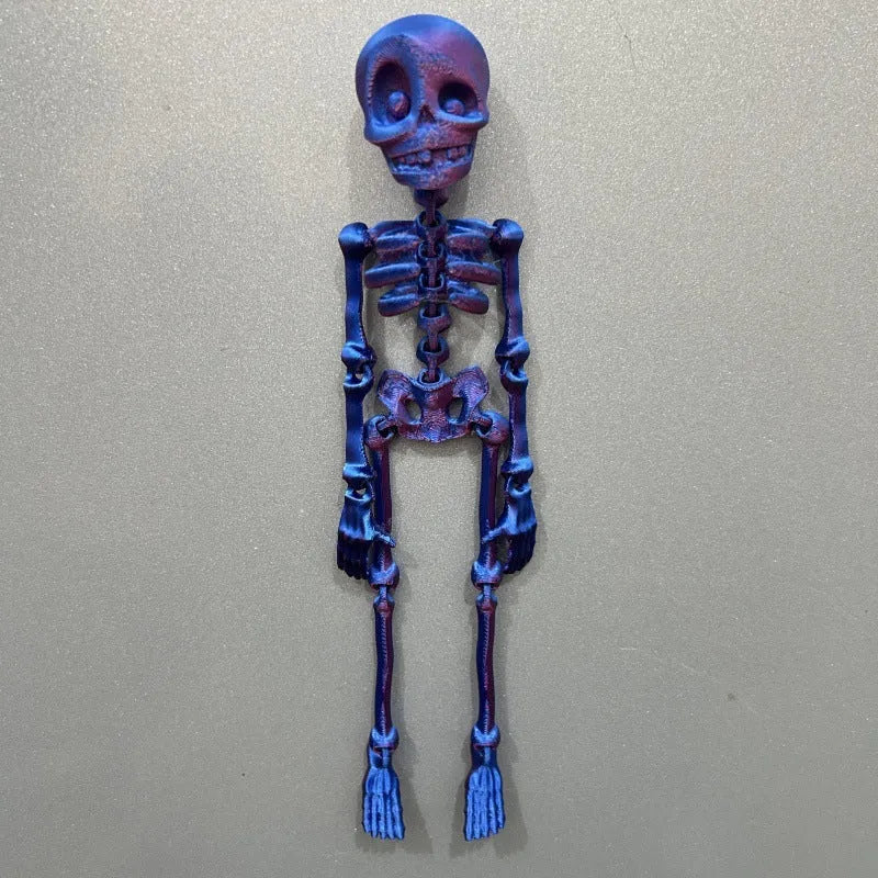 3D printed white skull refrigerator magnet with intricate details on a metallic surface.