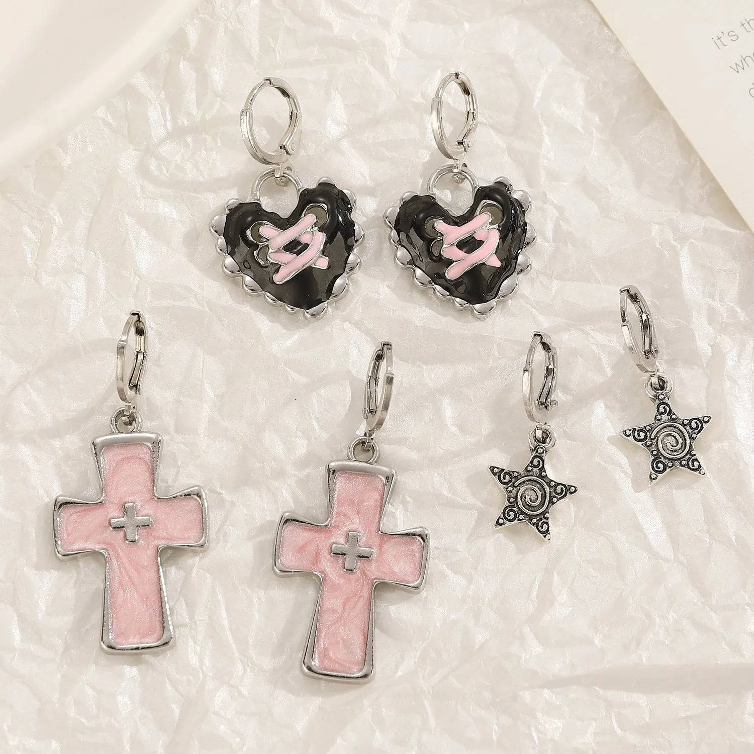 Women's classic alloy earrings with cross crystal design in five colour options on display