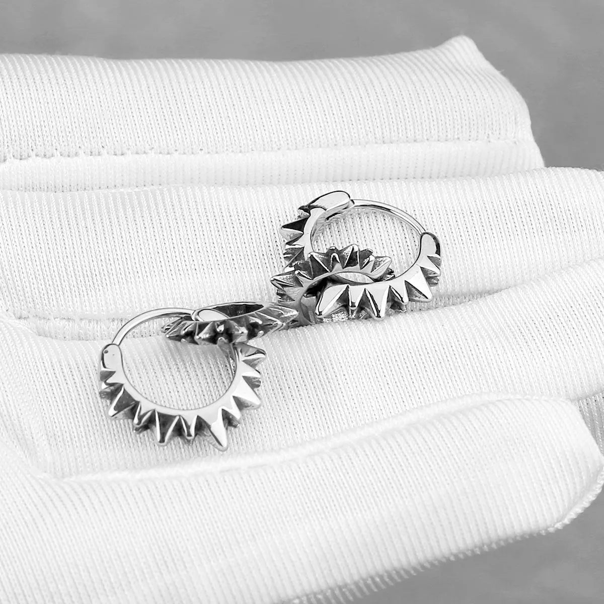 A pair of simple stainless steel round hoop earrings with a polished finish in a steel colour.