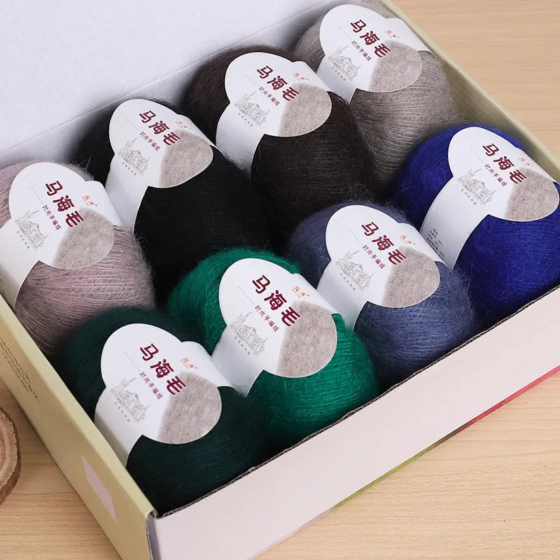 Ball of mohair yarn for DIY scarf knitting in one of 34 colours, including white, pink, blue, and green.