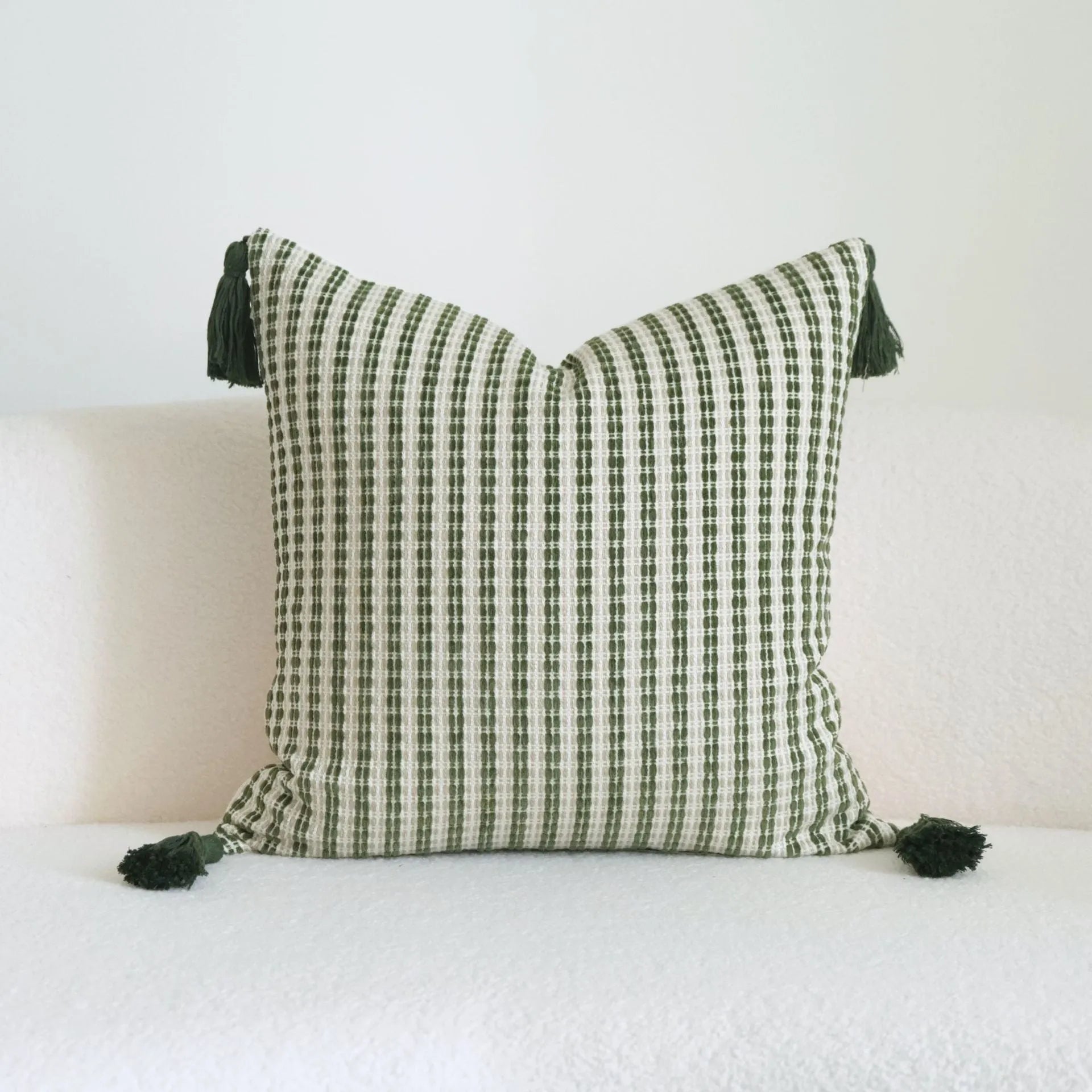 Green cotton and linen hotel sample pillow with tassel or beaded trim, shown in one of three pattern options.