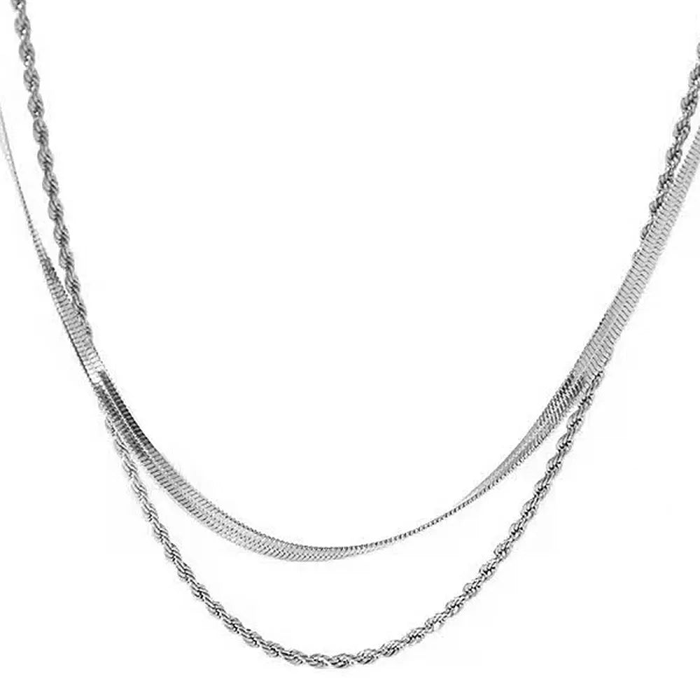 Women's silver geometric double-layer twist pendant on an adjustable snake chain necklace.