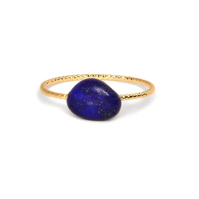 Original geometric design women's ring in coloured agate stone on a plain background.