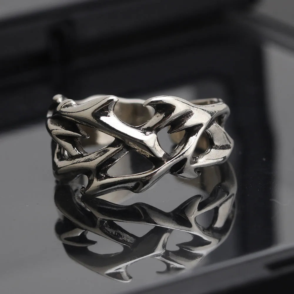Copper men's ring with geometric thorn and flower design and adjustable band.