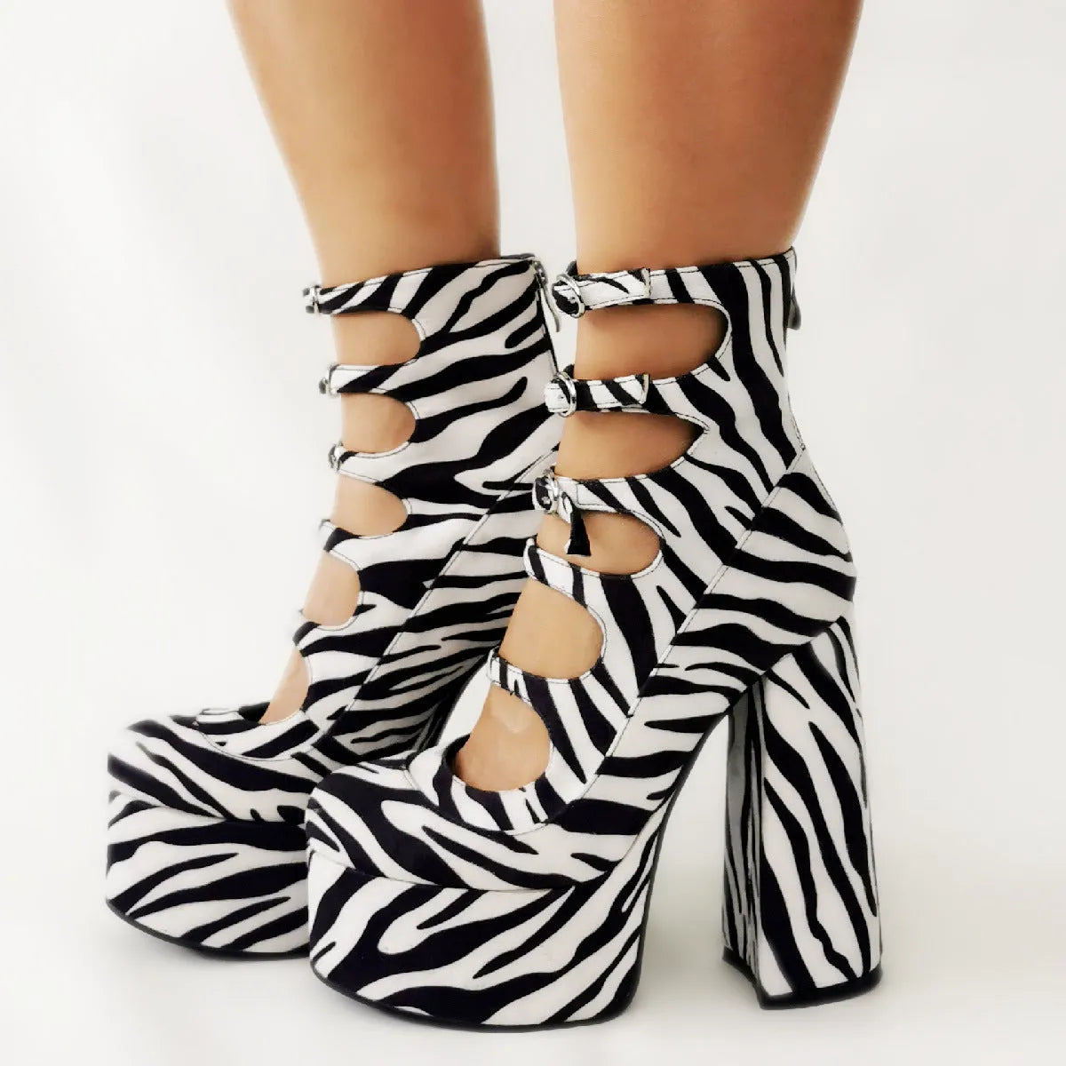 Women's black waterproof platform high-heel boots with a serpentine belt buckle fastening.