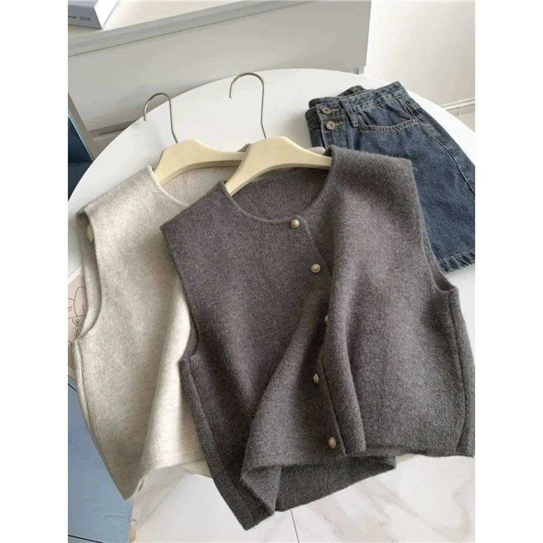 A smoky grey polyester half-sleeve pullover vest laid flat, showing its regular sleeve and commuter style.