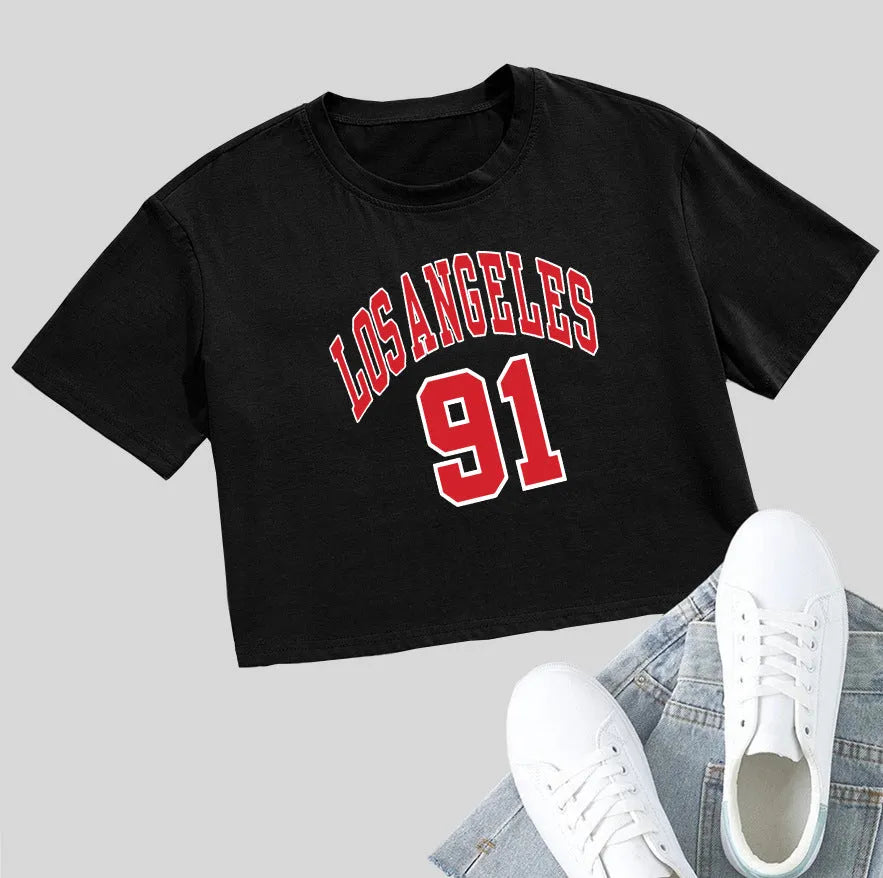 Women's black loose fit cotton T-shirt with exposed navel design and printed white English letters.