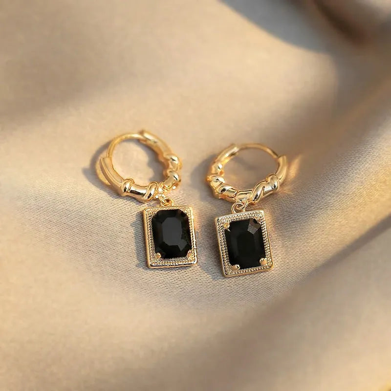 Pair of geometric black copper earrings with zircon accents in a retro French court style.