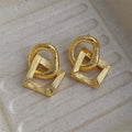 Geometric circle pendant earrings with retro styling in gold or silver electroplated colours measuring 3.4cm height