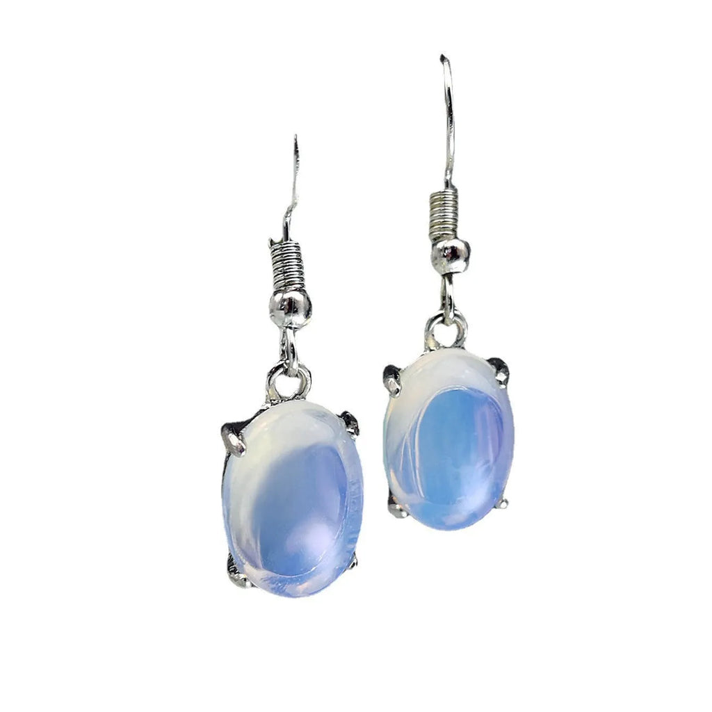 A pair of white opal-coloured drop earrings with a retro cross design on an alloy pendant.