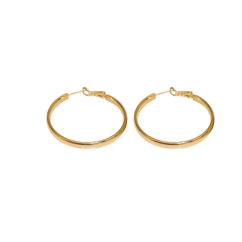 Large circular gold and silver metal hoop earrings measuring 40mm