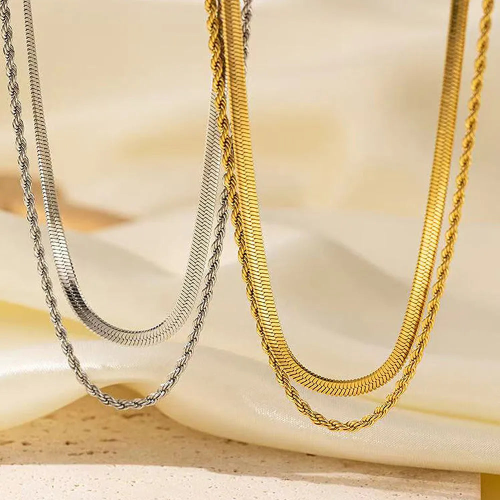 Women's silver geometric double-layer twist pendant on an adjustable snake chain necklace.