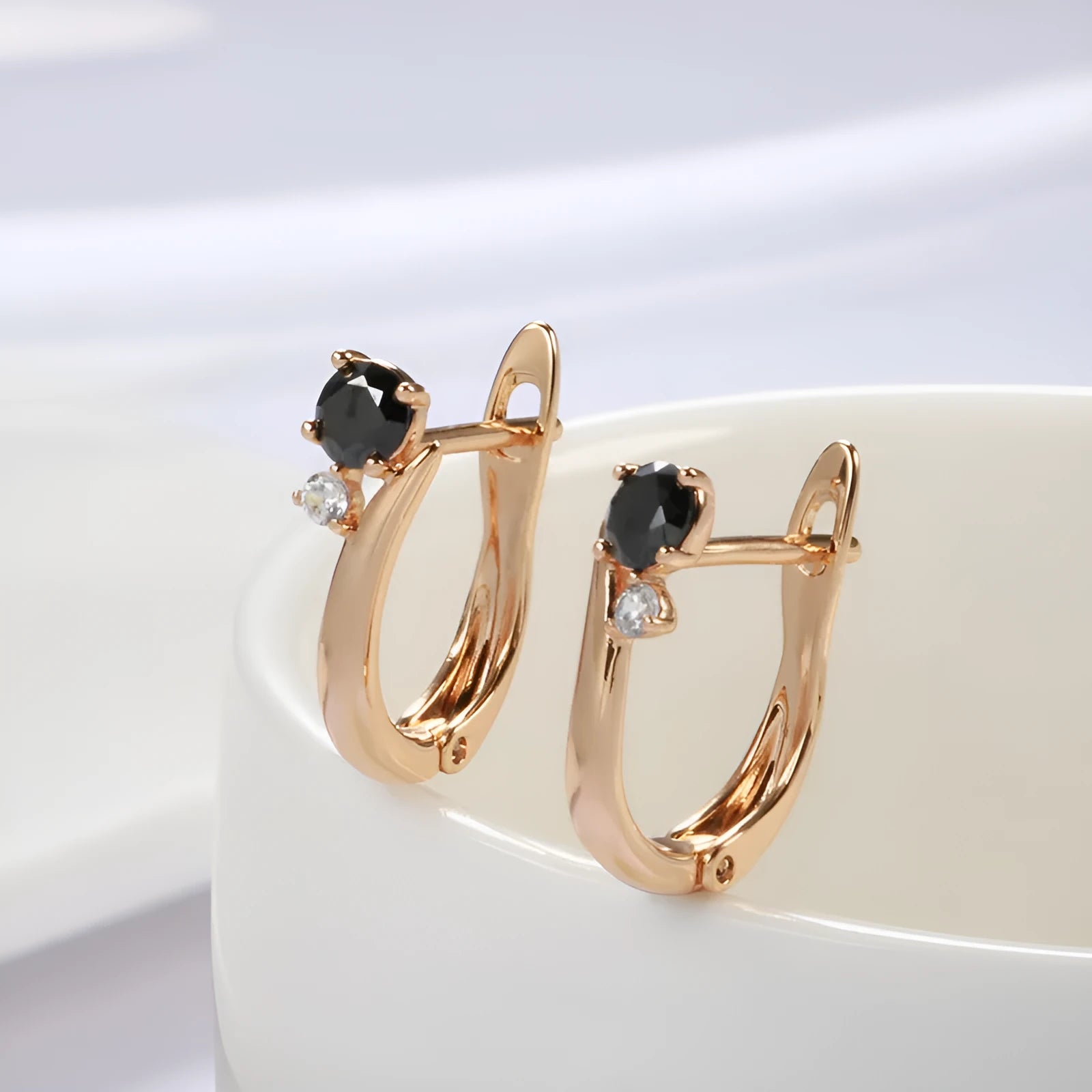 Gold-coloured drop earrings with geometric black agate design and retro styling