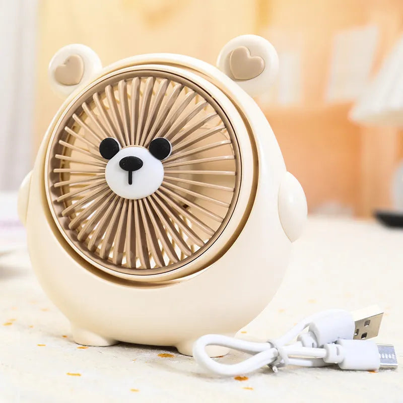 Small plastic desktop fan with a cute dog design, showing USB port and control buttons.
