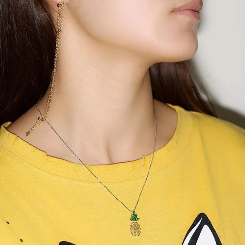 Silver geometric women's necklace with a pineapple and diamond motif pendant.