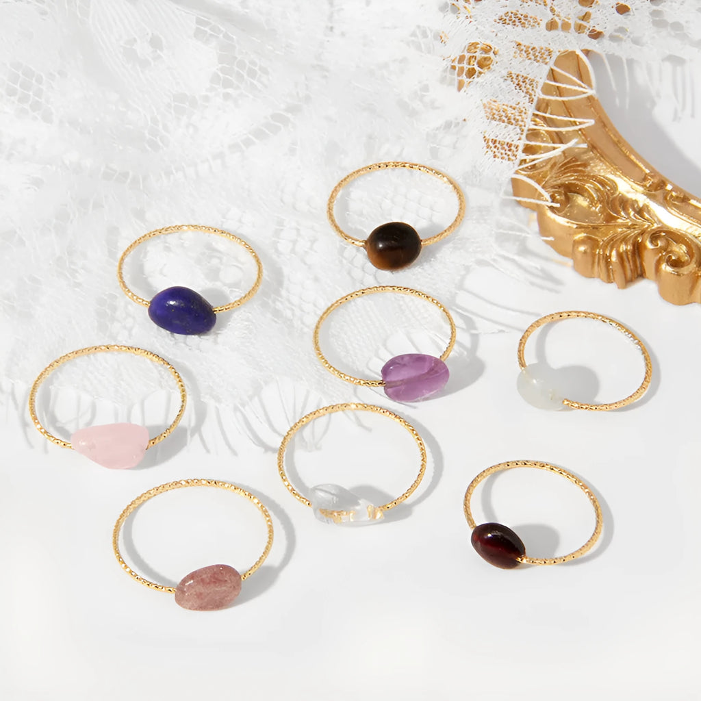 Original geometric design women's ring in coloured agate stone on a plain background.