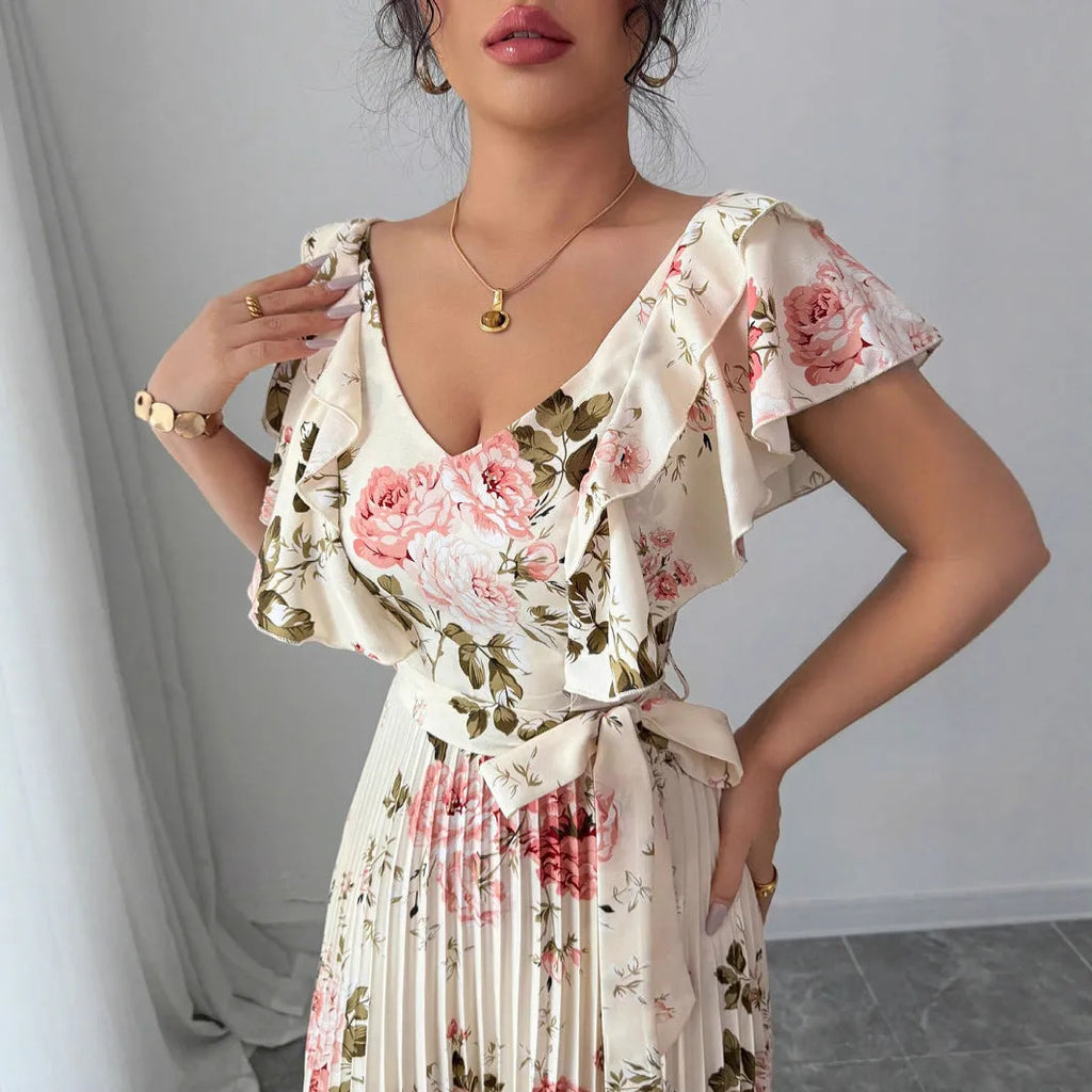Apricot floral print women's dress with v-neck, ruffled sleeves, and a high-waisted long swing skirt.