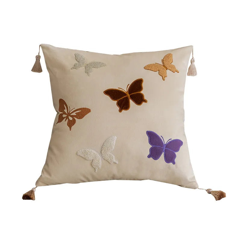 Square beige cushion with colourful embroidered butterfly and Chinese floral pattern.
