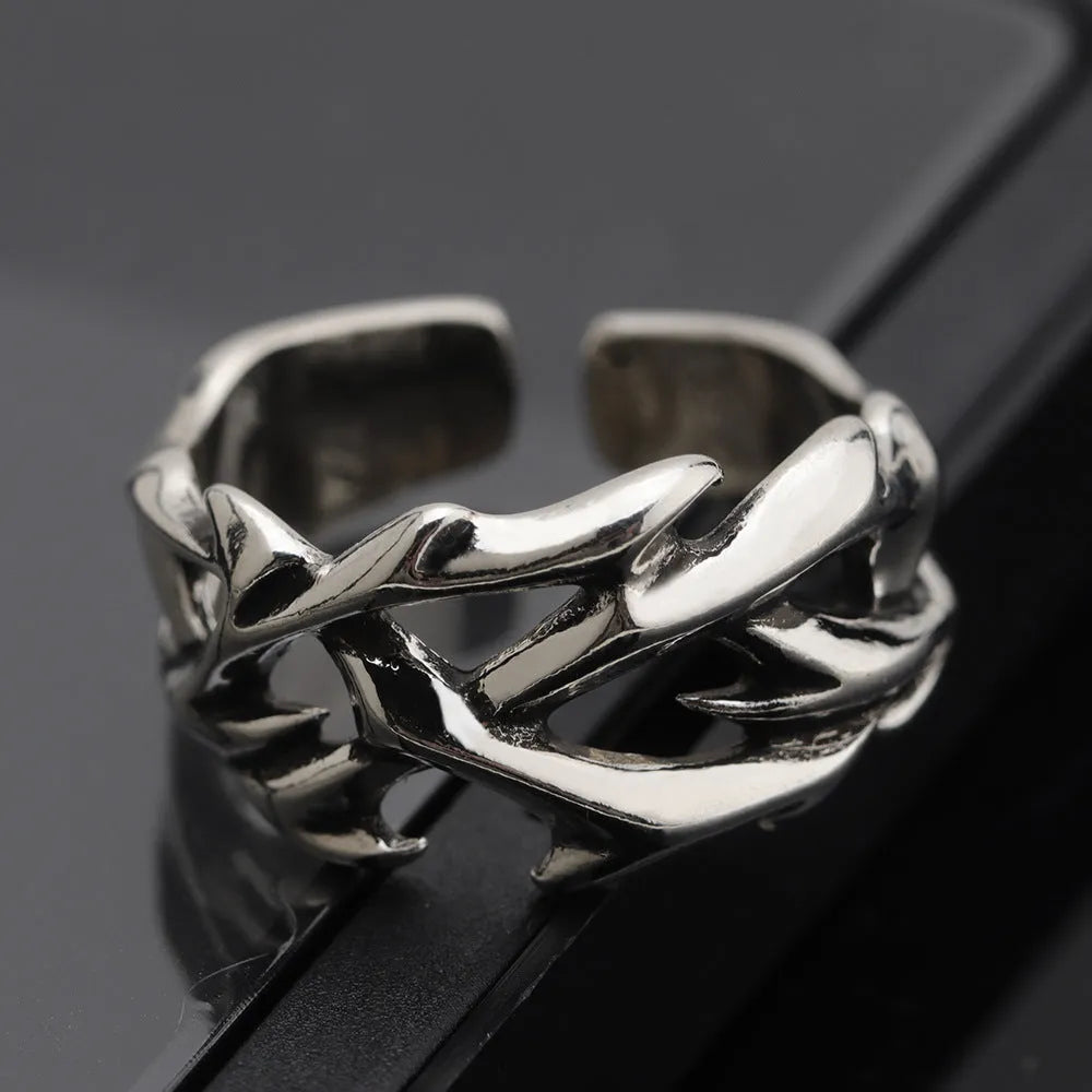 Copper men's ring with geometric thorn and flower design and adjustable band.