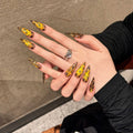 Handmade false nails with tiger pattern, leopard print and white base in a cat eye shape.