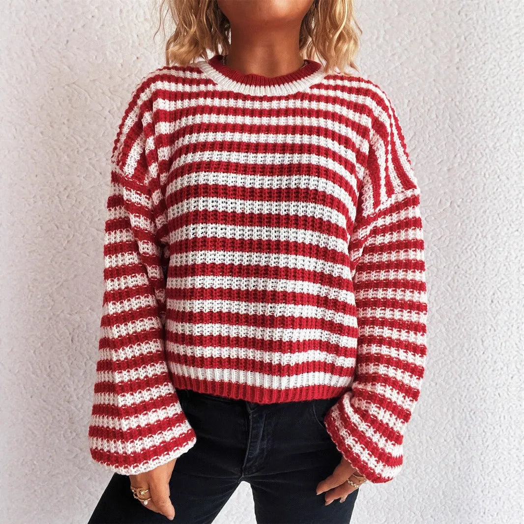 Women's loose vintage stripe knit pullover sweater in black on a hanger.