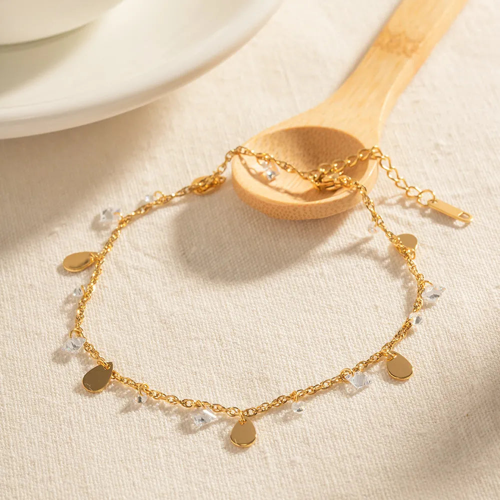 Stainless steel women's anklet with a geometric water drop tassel pendant on an adjustable chain.