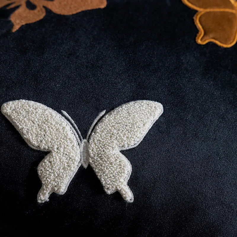 Square beige cushion with colourful embroidered butterfly and Chinese floral pattern.
