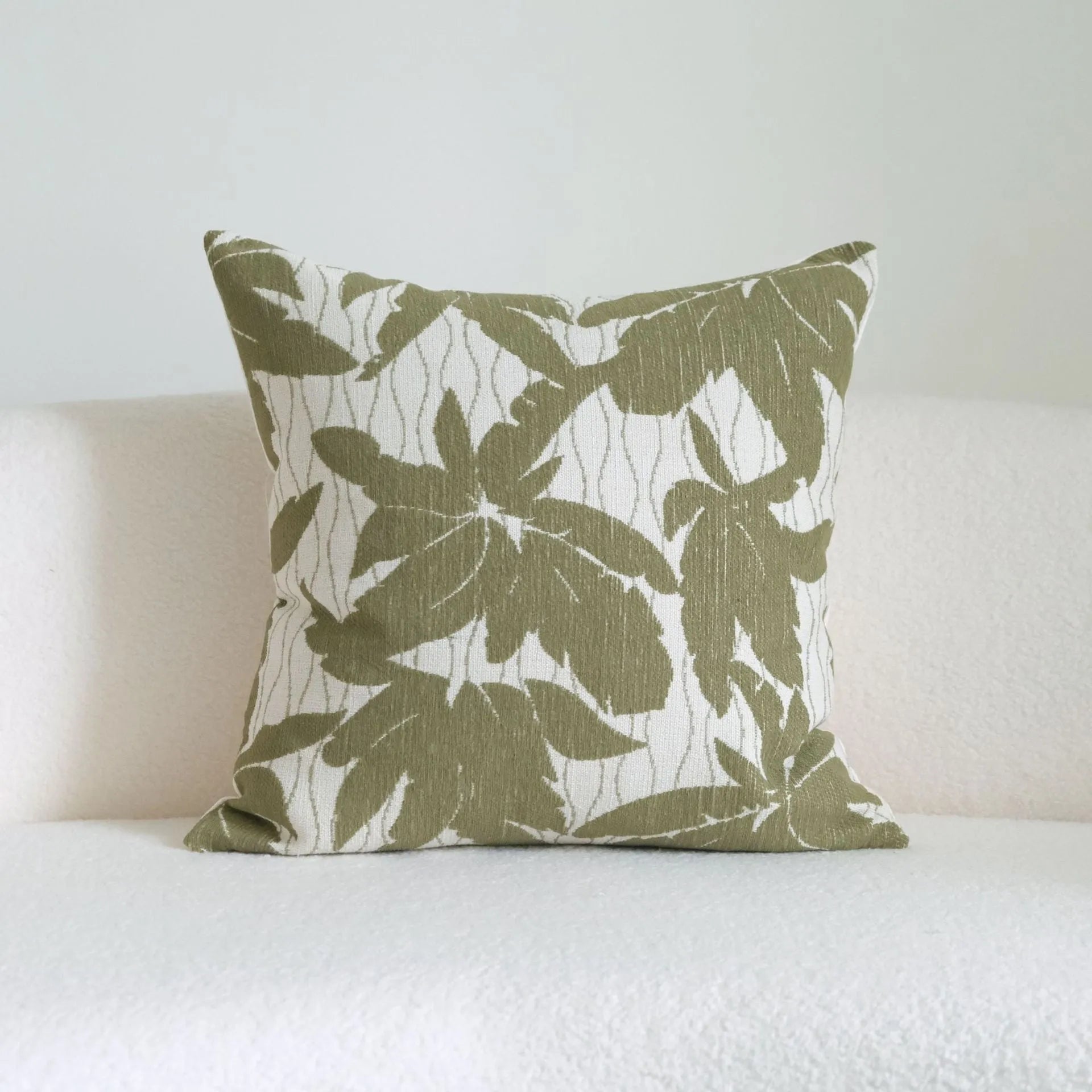 Green cotton and linen hotel sample pillow with tassel or beaded trim, shown in one of three pattern options.