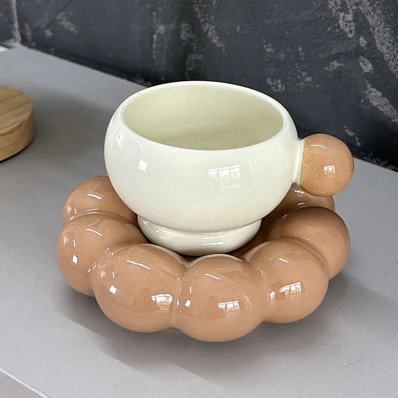 Ceramic coffee cup and saucer set in a simple Nordic design, shown in a choice of colours.