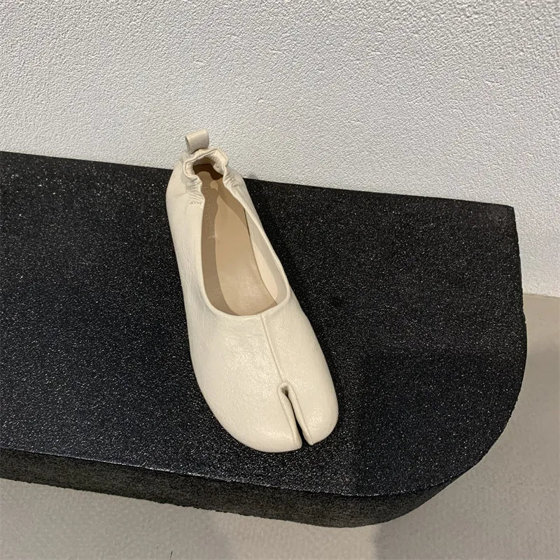 Women's apricot coloured chunky heel pumps with split toe horseshoe detail and round toe.