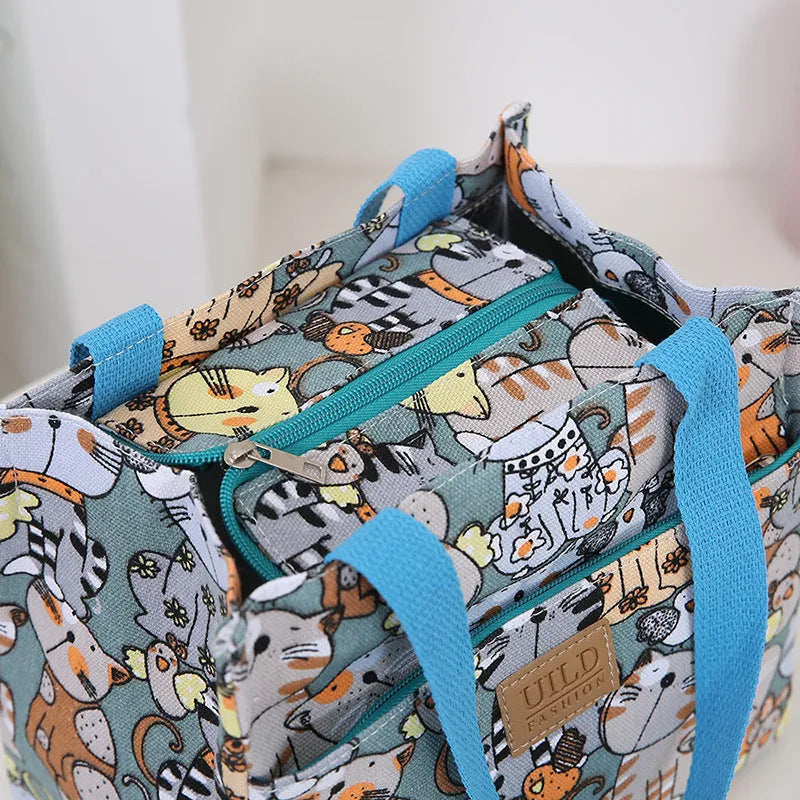 Women's printed floral canvas tote bag with aluminium frame open, showing large interior.