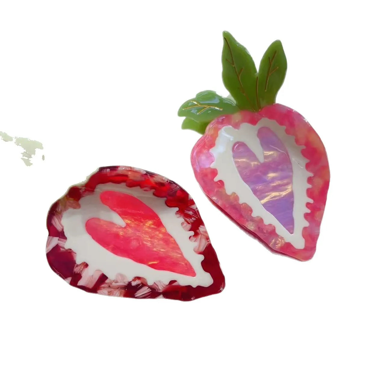Red and pink strawberry-shaped metal charm hair clip for girls on a white background.