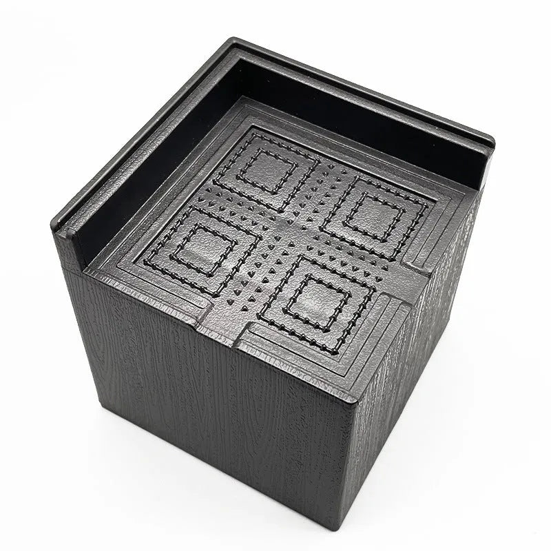 Four black plastic furniture foot mats for height adjustment and floor protection