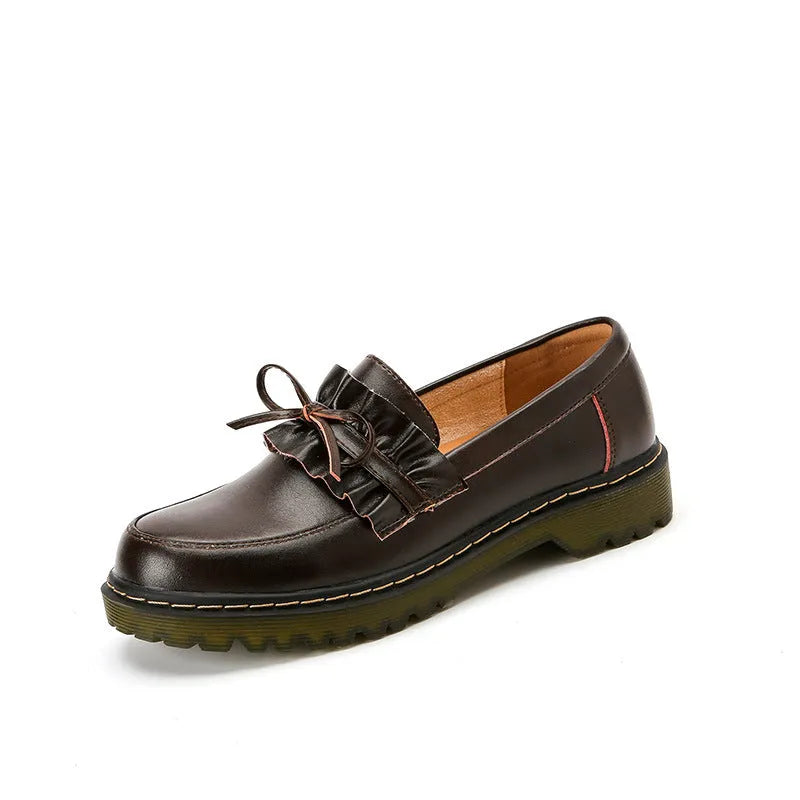 Black round-toe women's leather shoes with a chunky flat heel on a white background