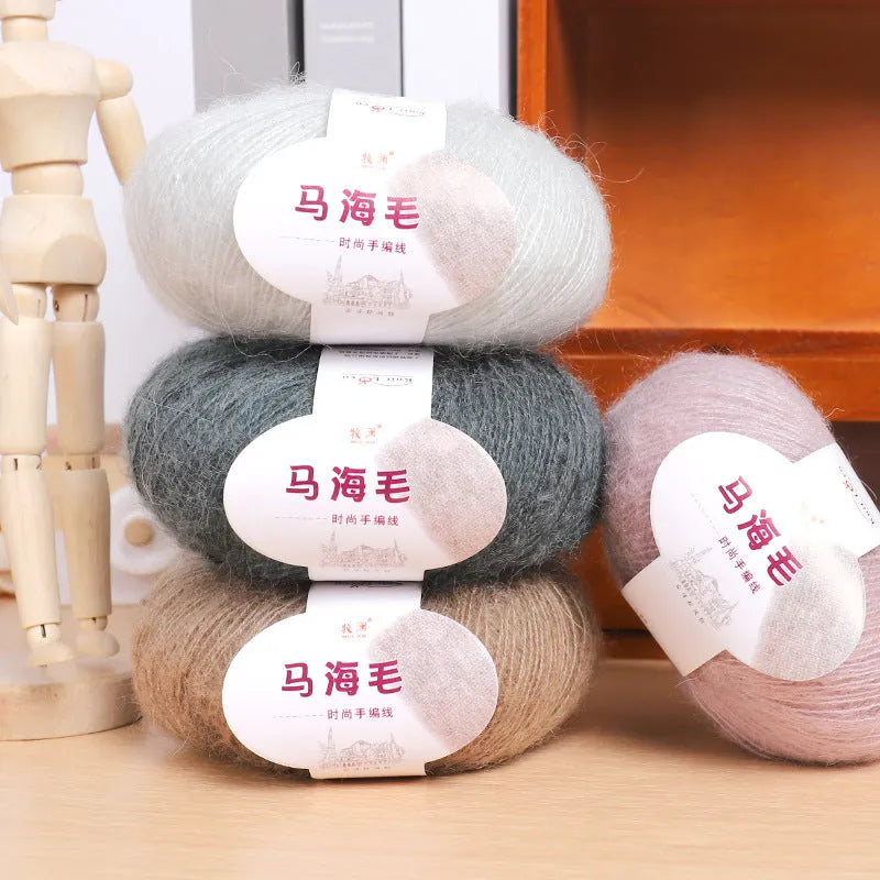 Ball of mohair yarn for DIY scarf knitting in one of 34 colours, including white, pink, blue, and green.