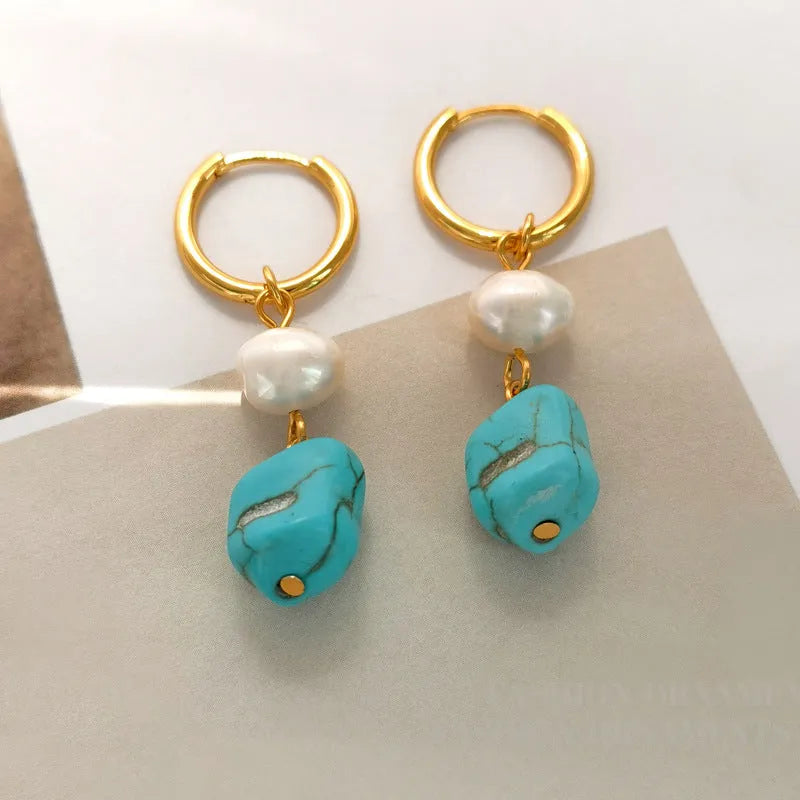 A set of two pairs of women's ear clips: one short and one dangle style, with geometric copper design, turquoise, and cultured pearls.