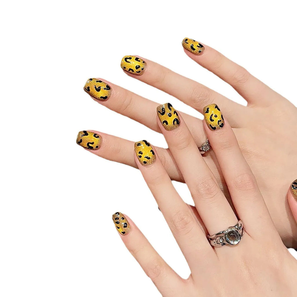 Handmade false nails with tiger pattern, leopard print and white base in a cat eye shape.